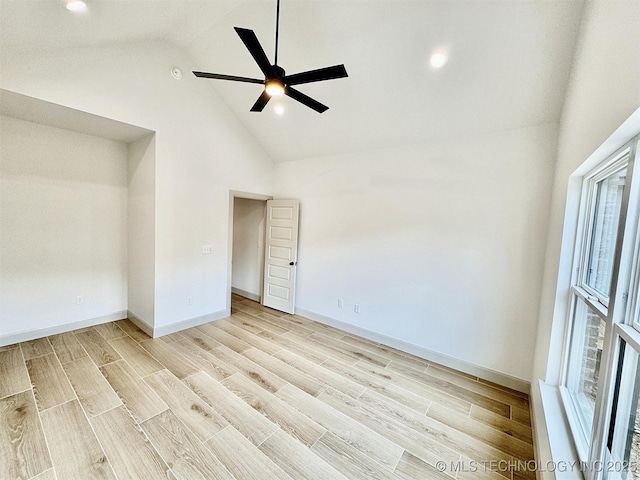 unfurnished bedroom featuring light wood-style floors, high vaulted ceiling, and multiple windows