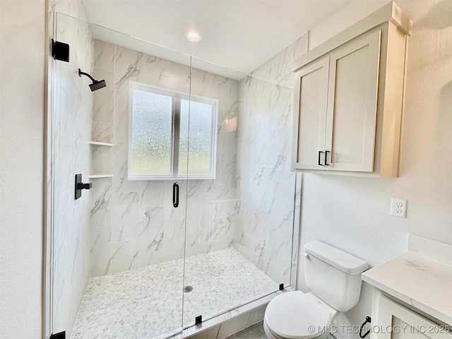 full bathroom with vanity, a marble finish shower, and toilet