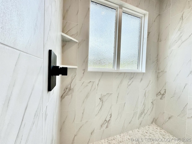 bathroom with tiled shower