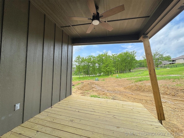 wooden terrace featuring a ceiling fan