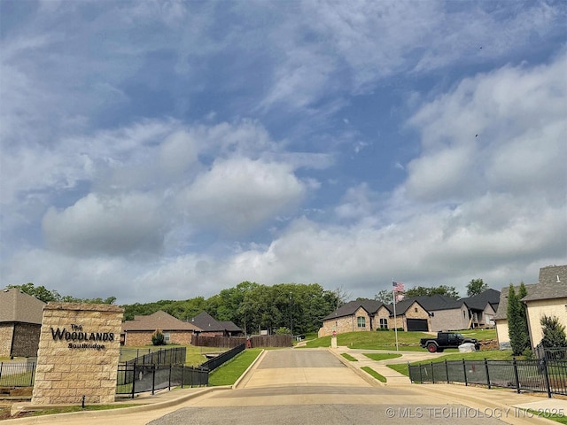 view of road with a residential view, sidewalks, and curbs