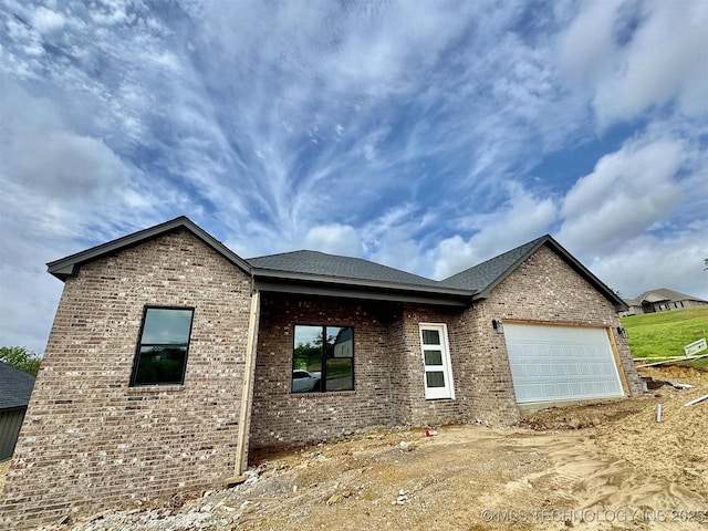 view of front facade with an attached garage and brick siding