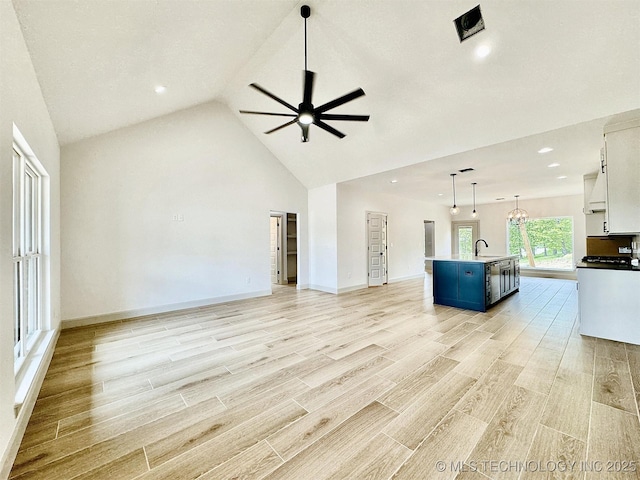 unfurnished living room with recessed lighting, ceiling fan, a sink, and light wood-style flooring