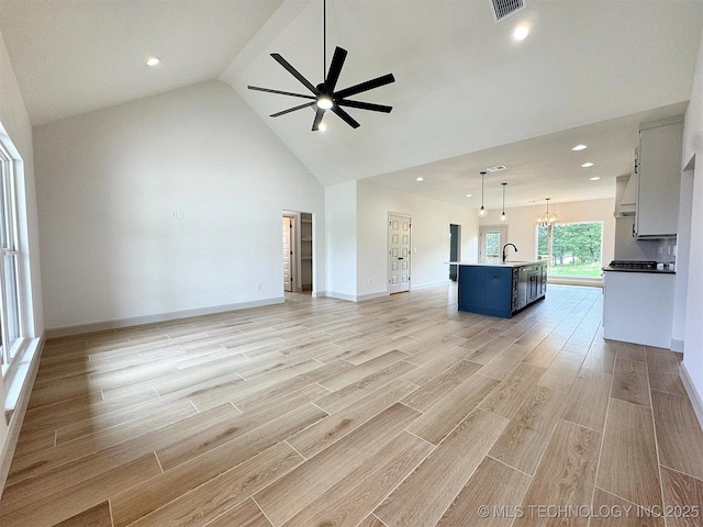 566 Woodlands Dr, Tahlequah, OK 74464 - unfurnished living room with ceiling fan, recessed lighting, high vaulted ceiling, a sink, and light wood-style flooring