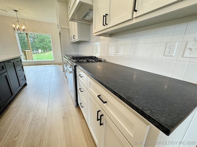 566 Woodlands Dr, Tahlequah, OK 74464 - kitchen featuring high end range, ventilation hood, light wood-style floors, and decorative backsplash