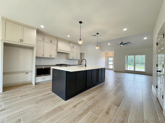 566 Woodlands Dr, Tahlequah, OK 74464 - kitchen with custom range hood, light wood-type flooring, ceiling fan, light countertops, and recessed lighting