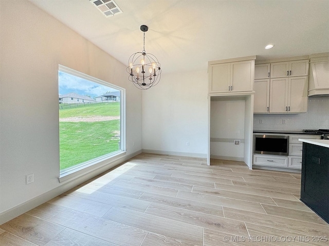 566 Woodlands Dr, Tahlequah, OK 74464 - kitchen featuring a chandelier, custom range hood, stove, hanging light fixtures, and backsplash