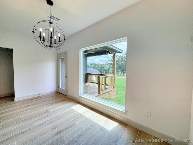 566 Woodlands Dr, Tahlequah, OK 74464 - spare room featuring a chandelier, baseboards, and light wood finished floors
