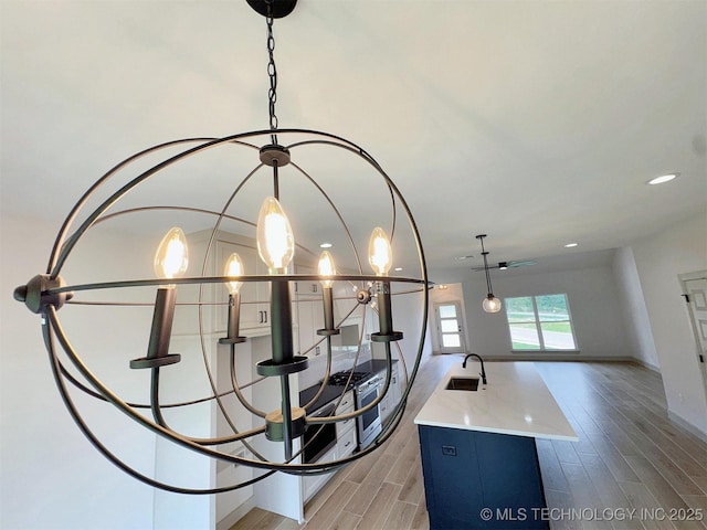 566 Woodlands Dr, Tahlequah, OK 74464 - detailed view of a sink, wood finished floors, baseboards, and recessed lighting