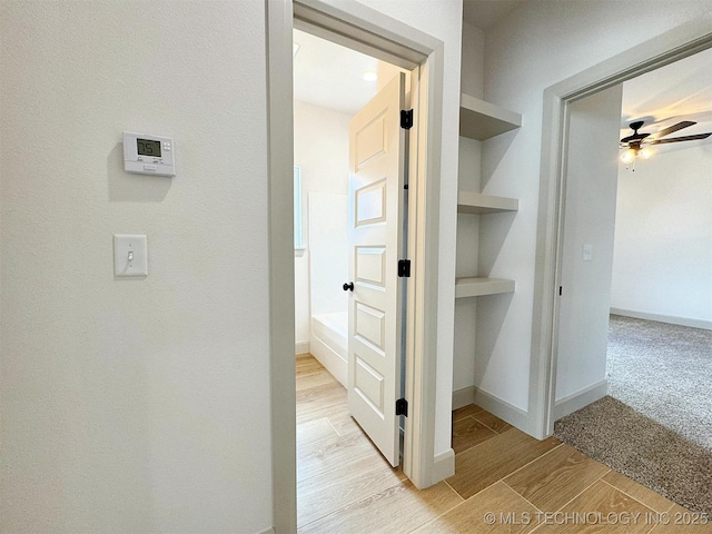 566 Woodlands Dr, Tahlequah, OK 74464 - hall featuring light wood finished floors, baseboards, and built in features