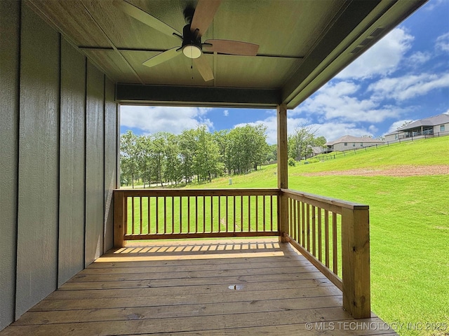 566 Woodlands Dr, Tahlequah, OK 74464 - wooden deck featuring a ceiling fan and a lawn