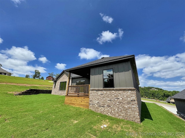 566 Woodlands Dr, Tahlequah, OK 74464 - view of side of property with brick siding, a lawn, and board and batten siding
