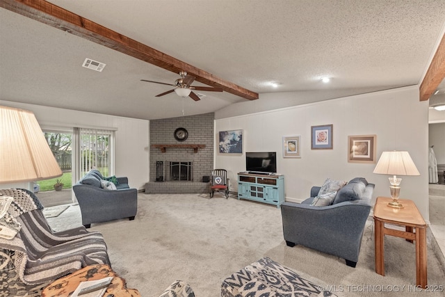 carpeted living room with a textured ceiling, visible vents, lofted ceiling with beams, a fireplace, and a ceiling fan