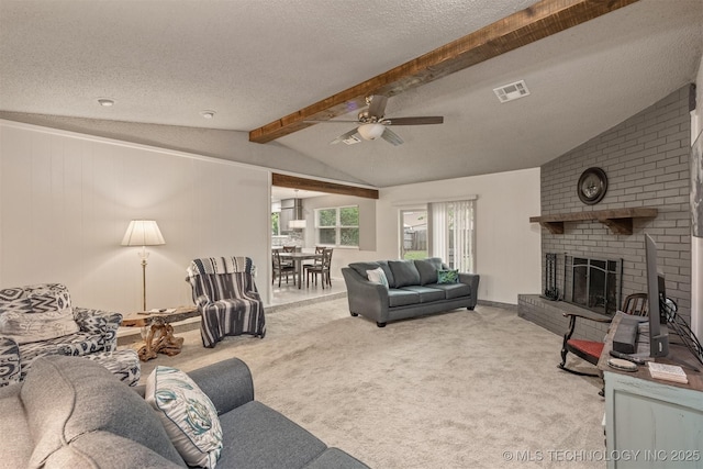 carpeted living room featuring a ceiling fan, visible vents, vaulted ceiling with beams, and a textured ceiling