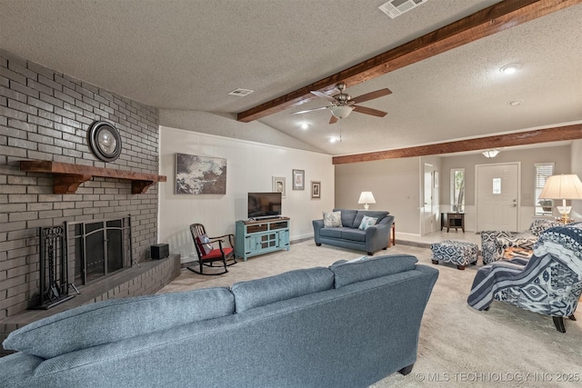carpeted living area featuring a textured ceiling, visible vents, a brick fireplace, a ceiling fan, and vaulted ceiling with beams