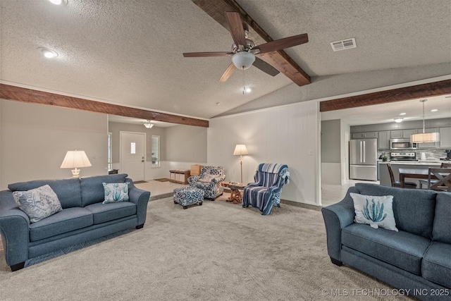 carpeted living area featuring a textured ceiling, visible vents, and ceiling fan