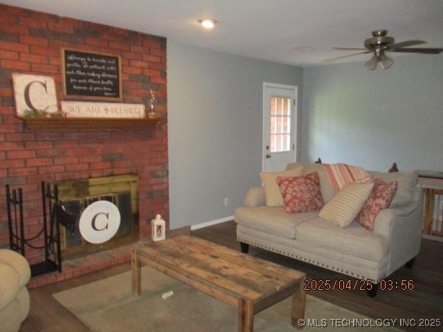 61 Cedar, Ardmore, OK 73401 - living area featuring wood finished floors, a ceiling fan, and a fireplace