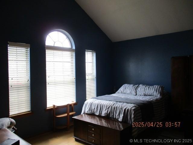 61 Cedar, Ardmore, OK 73401 - bedroom featuring light wood finished floors and vaulted ceiling