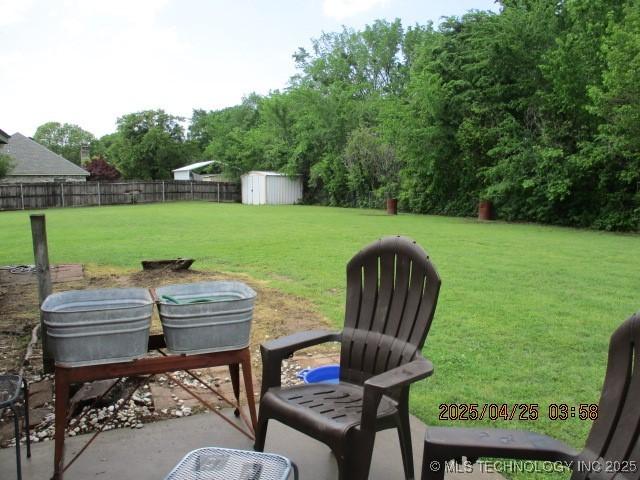 61 Cedar, Ardmore, OK 73401 - view of yard with an outdoor structure, a shed, and a fenced backyard