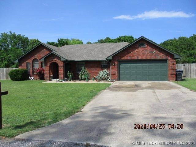 61 Cedar, Ardmore, OK 73401 - ranch-style home with a front lawn, an attached garage, and brick siding