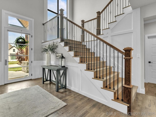 13651 S 26th St, Jenks, OK 74008 - foyer with wood finished floors, stairway, wainscoting, a high ceiling, and a decorative wall