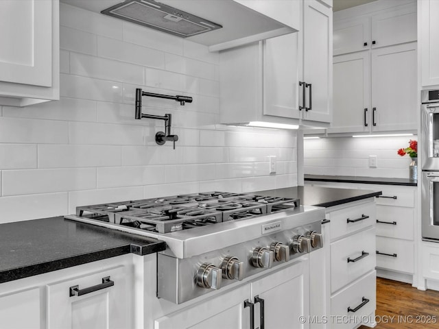 13651 S 26th St, Jenks, OK 74008 - kitchen featuring stainless steel gas stovetop, dark countertops, and white cabinets