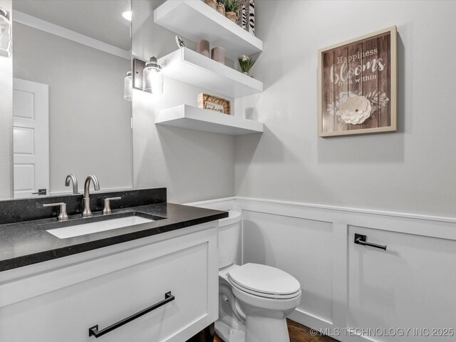13651 S 26th St, Jenks, OK 74008 - half bathroom with a wainscoted wall, toilet, vanity, a decorative wall, and ornamental molding