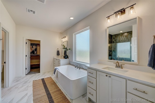 1500 N 72nd St, Broken Arrow, OK 74014 - full bath featuring a sink, marble finish floor, a freestanding bath, two vanities, and visible vents
