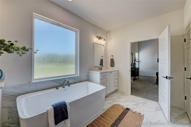 1500 N 72nd St, Broken Arrow, OK 74014 - bathroom with vanity, a freestanding bath, marble finish floor, and baseboards