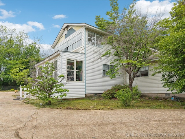 view of side of home featuring crawl space