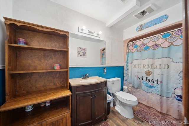 bathroom with vanity, shower / bath combination with curtain, toilet, visible vents, and wood finished floors