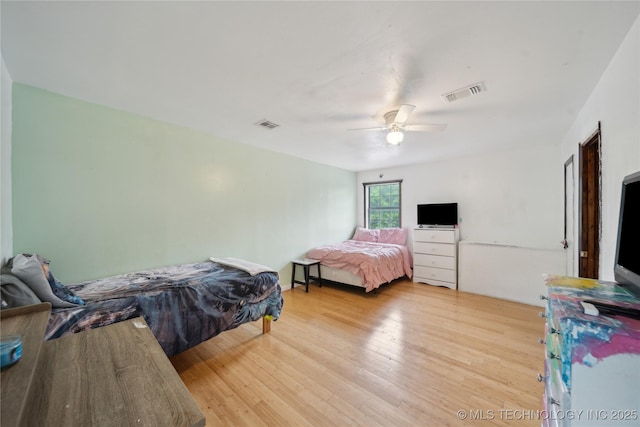 bedroom with visible vents, ceiling fan, and light wood-style floors