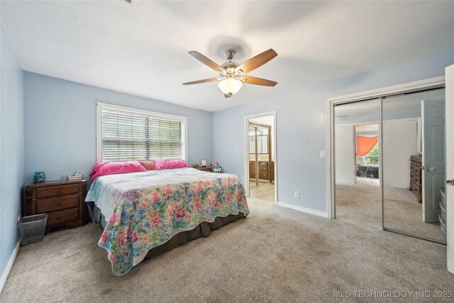 bedroom with baseboards, a ceiling fan, carpet floors, and connected bathroom