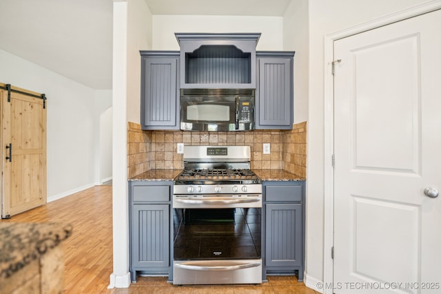 13323 S 21st St, Bixby, OK 74008 - kitchen featuring black microwave, stainless steel range with gas stovetop, gray cabinets, light stone counters, and a barn door