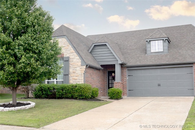 cape cod house with a shingled roof, driveway, brick siding, and a front yard