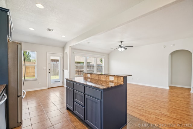 13323 S 21st St, Bixby, OK 74008 - kitchen featuring freestanding refrigerator, arched walkways, open floor plan, ceiling fan, and recessed lighting