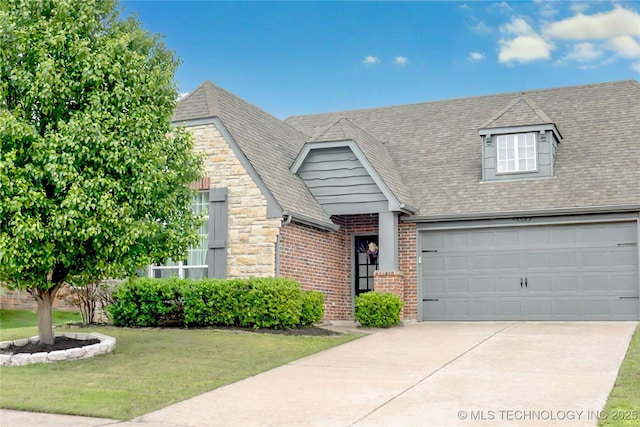 13323 S 21st St, Bixby, OK 74008 - view of front of home with driveway, a front yard, stone siding, and brick siding