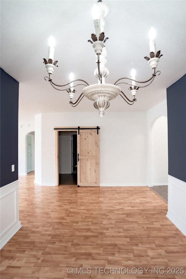 13323 S 21st St, Bixby, OK 74008 - unfurnished dining area with arched walkways, a chandelier, and light wood-style floors