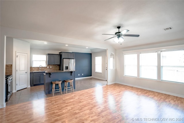 13323 S 21st St, Bixby, OK 74008 - living room with a ceiling fan, light wood-type flooring, plenty of natural light, baseboards, and recessed lighting