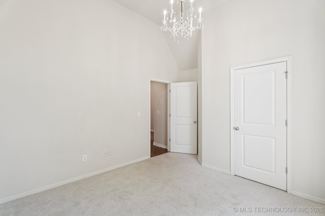 13323 S 21st St, Bixby, OK 74008 - unfurnished bedroom featuring carpet, a chandelier, and high vaulted ceiling