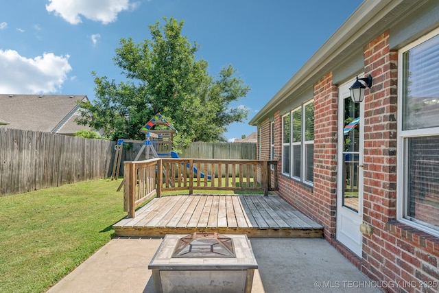 13323 S 21st St, Bixby, OK 74008 - wooden deck with an outdoor fire pit, a patio, a playground, and a fenced backyard