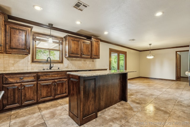 5601 S 9th E, Muskogee, OK 74403 - kitchen featuring crown molding, a sink, decorative backsplash, and pendant lighting