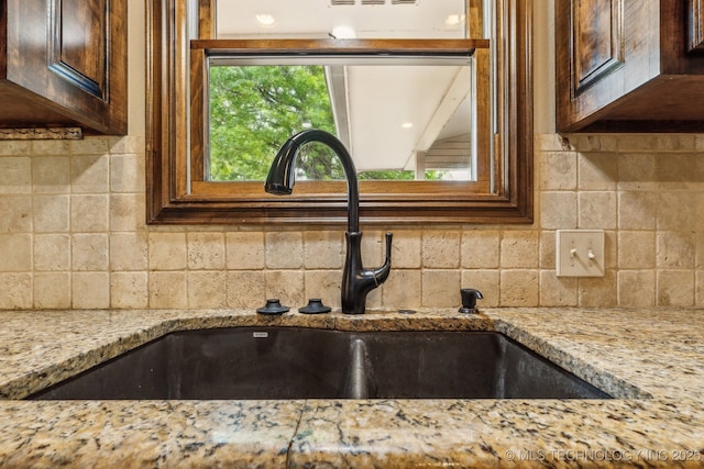 5601 S 9th E, Muskogee, OK 74403 - room details with tasteful backsplash, light stone counters, dark brown cabinetry, and a sink