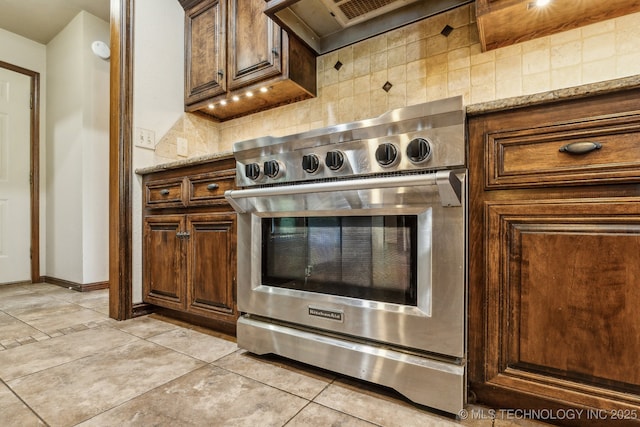 5601 S 9th E, Muskogee, OK 74403 - interior details featuring high end stainless steel range, light stone counters, decorative backsplash, and baseboards