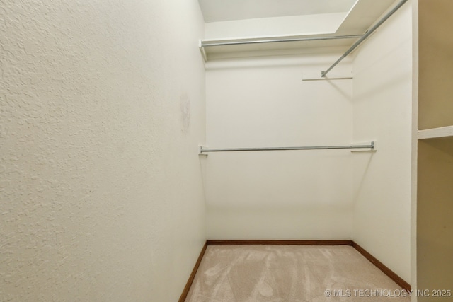 5601 S 9th E, Muskogee, OK 74403 - walk in closet featuring light colored carpet