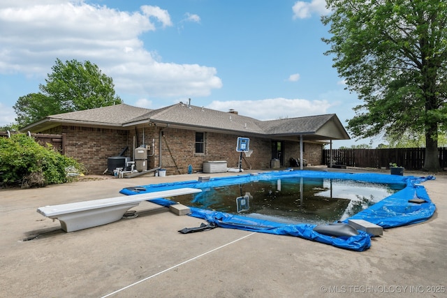 5601 S 9th E, Muskogee, OK 74403 - view of pool with a diving board, a patio, a fenced in pool, and fence