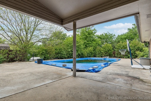 5601 S 9th E, Muskogee, OK 74403 - view of swimming pool with fence, a diving board, a patio area, and a covered pool