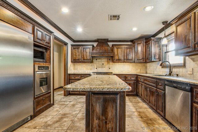5601 S 9th E, Muskogee, OK 74403 - kitchen with custom exhaust hood, appliances with stainless steel finishes, backsplash, and a kitchen island