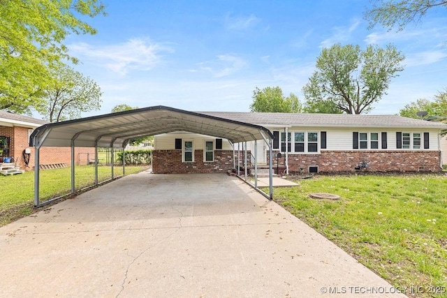 view of front of house with driveway, a detached carport, a front yard, and brick siding