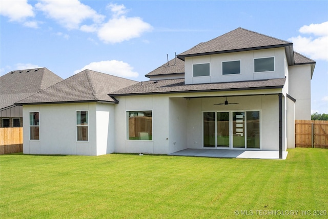 rear view of property featuring fence, ceiling fan, a patio area, and a shingled roof